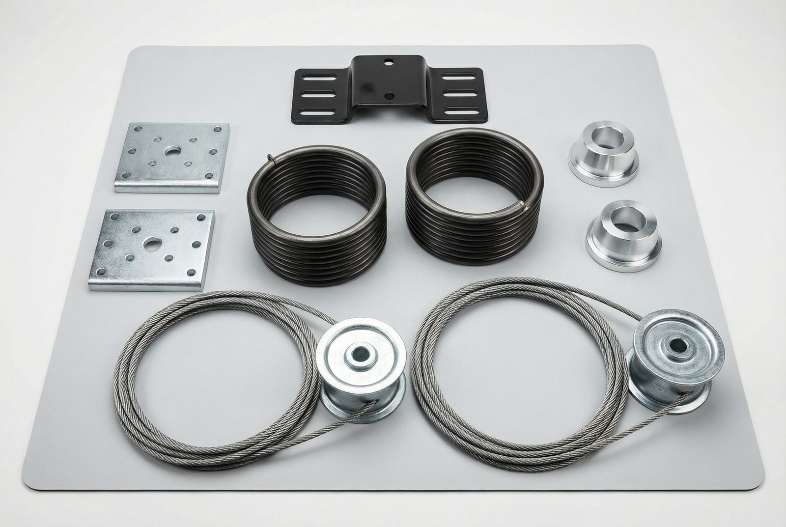 Close-up of garage door spring hardware including winding cone and cable drum